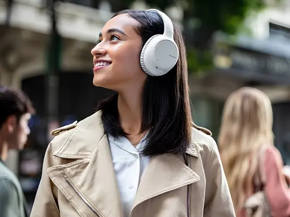 woman with white sony over-ear headphone