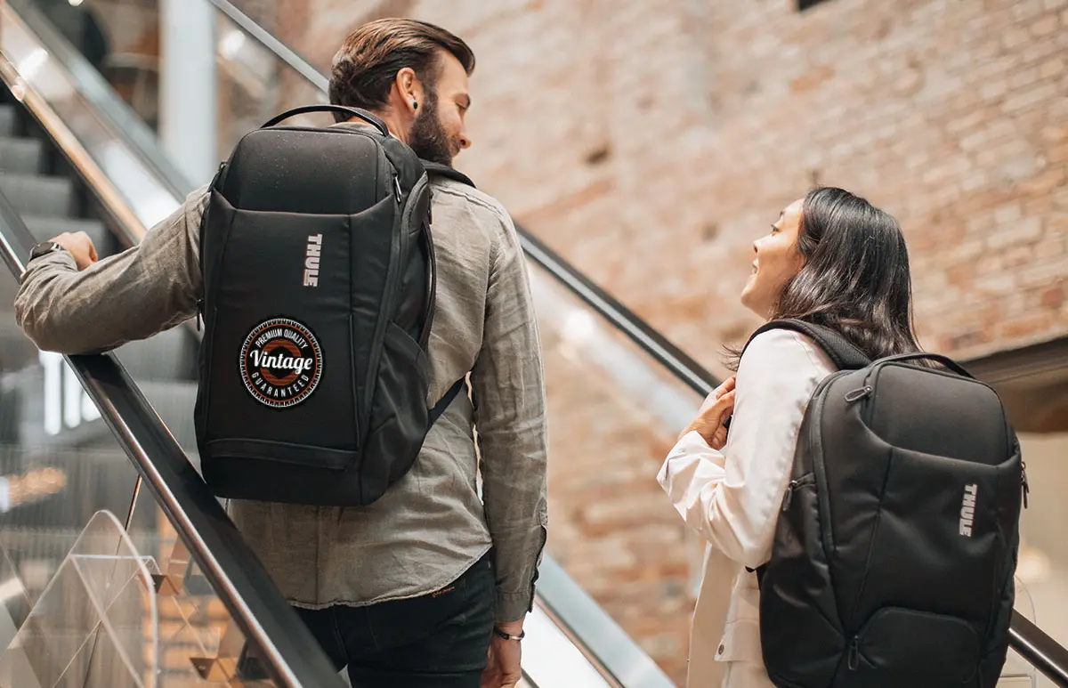 People with Thule backpacks on escalator